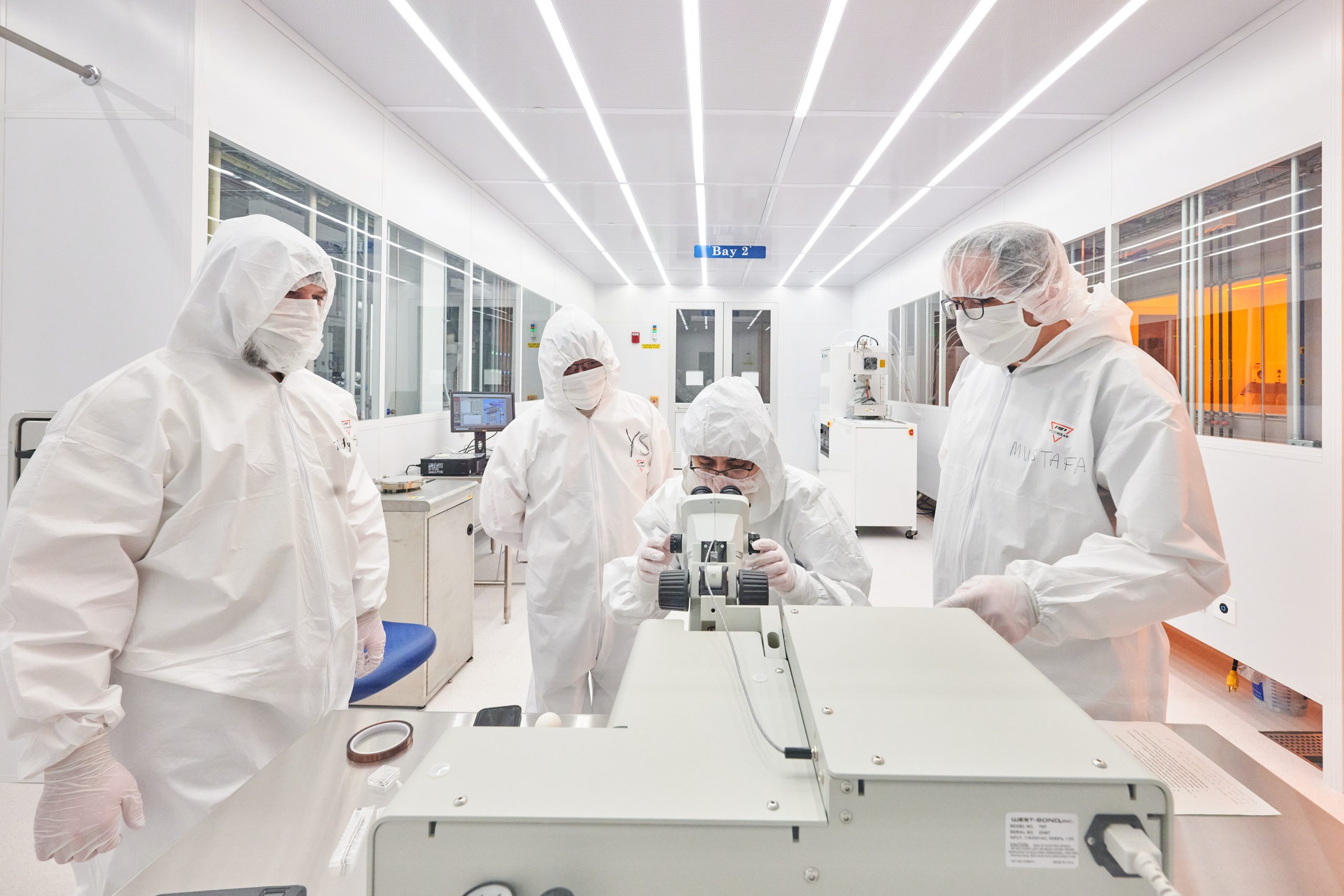 Mustafa Yavuz, right, and others work in the clean room at Science 1